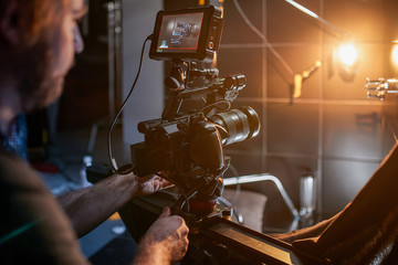 Behind the scenes of filming movies and video products, setting up equipment for shooting video and sound. The concept of producing video content for social networks, TV and blogs.