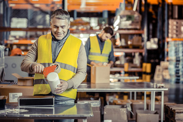 Wall Mural - Cheerful mature man working with great pleasure