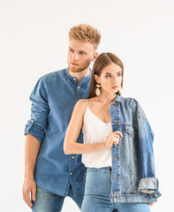 Fashionable young couple in stylish casual clothes on white background