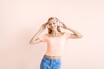 Sticker - Beautiful young woman listening to music on color background