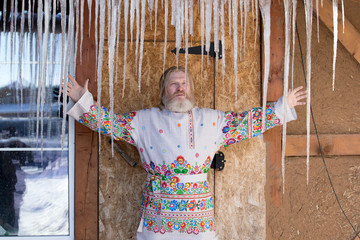 Wall Mural - man in a beautiful national painted shirt in the courtyard of the house