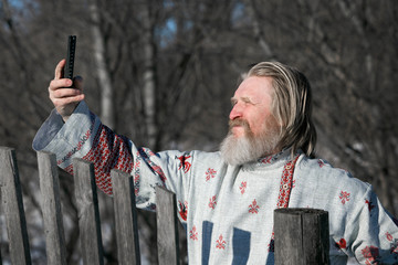 Wall Mural - man in a beautiful national painted shirt does selfie