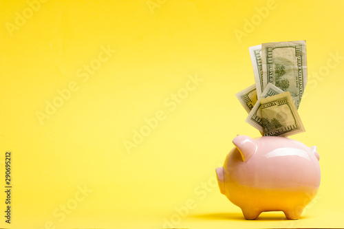 Cuadros en Lienzo Piggy bank isolated on yellow background. Savings concept
