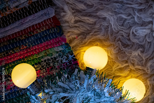 Chrismas garland lights over color carpet.