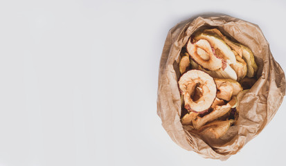 Wall Mural - panorama of tasty dried apples chips in paper bag, banner