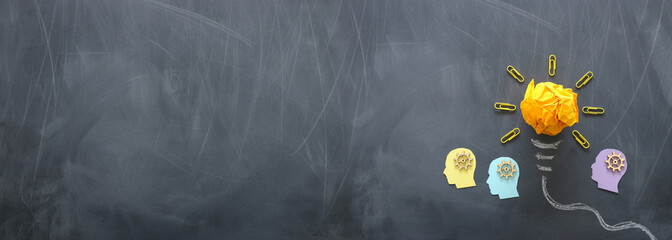 Wall Mural - Education concept image. Creative idea and innovation. Crumpled paper as light bulb metaphor over blackboard