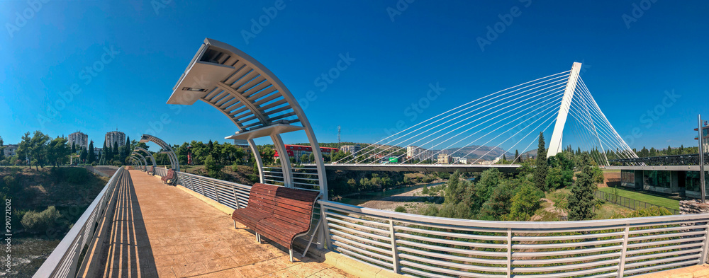 Obraz na płótnie Panoramic view of the Millenium Brigde, from a project by Santiago Calatrava, seen from the Moscow Bridge. Modern architecture of the capital of Montenegro. Podgorica. 09/15/2019 w salonie