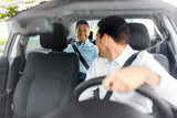 Fototapeta  - transportation, vehicle and people concept - middle aged male passenger talking to car driver