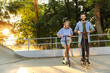 © Drobot Dean - Image of caucasian happy couple smiling while riding e-scooters