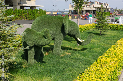 Cub And Mother Elephants Created From Bushes In Green Animals