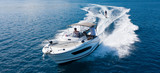 Speedboat with wakeboard rider on open sea