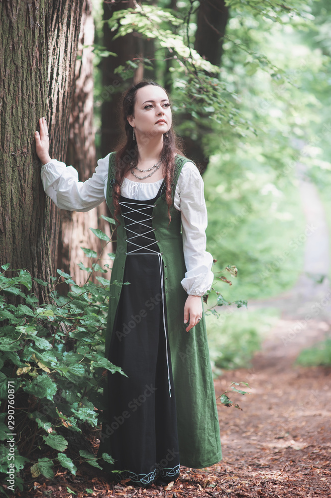 Beautiful woman in green medieval dress outdoor Stock Photo | Adobe Stock