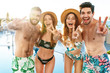 © Drobot Dean - Group of cheerful friends standing together at the poolside