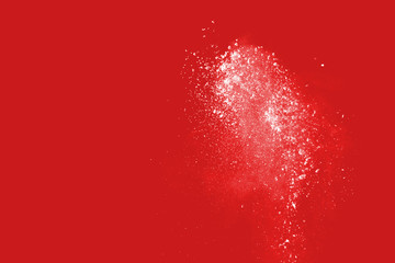 Wall Mural - explosion of colored powder on redbackground