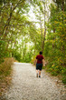 © Elena Blokhina - Young man walks along a path in a mountain forest.