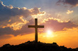 Cross on mountain sunset background. Easter concept. Concept conceptual black cross religion symbol silhouette in grass over sunset or sunrise sky.