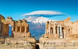 Fototapeta  - Ancient Greek theatre in Taormina on background of Etna Volcano, Italy