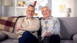 © motortion - Two satisfied gentlemen sitting home sofa looking camera, social support pension