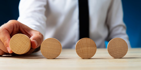 Wall Mural - placing four blank wooden circles in a row
