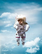 Astronaut floating in stratosphere of planet Earth. CLouds and blue sky on background. Under space. Elements of this image furnished by NASA.