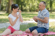 © auremar - playful mid-adult couple on picnic blanket