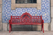 © Lara - beautiful red antique bench with typical portuguese blue and white tiles at background