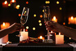 canvas print picture - Young couple with glasses of champagne having romantic candlelight dinner at table, closeup
