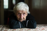 Fototapeta  - Portrait of a lonely gray-haired old woman in his home.