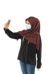 asian woman wearing face masks due to the haze situation while video call using a smart phone