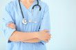 © Pixel-Shot - Female nurse with stethoscope on color background, closeup