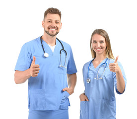 Poster - Male and female nurses showing thumb-up on white background