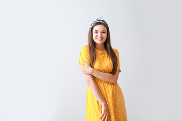 Sticker - Portrait of happy young woman on grey background