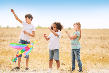 Canvas Print - Little children flying kite outdoors