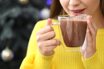 Sticker - Beautiful woman drinking hot chocolate at home, closeup