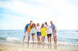 © Pixel-Shot - Happy friends on sea beach at resort
