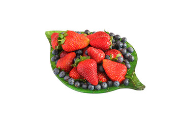 Strawberry and blueberry on green plate isolated on white background