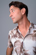 © Ranta Images - Closeup profile view of handsome Hispanic tourist man thinking
