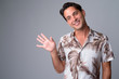 © Ranta Images - Face of happy handsome Hispanic tourist man waving hand
