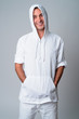 © Ranta Images - Portrait of happy handsome Hispanic man smiling wearing hooded shirt