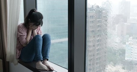 Wall Mural - woman cry near by window