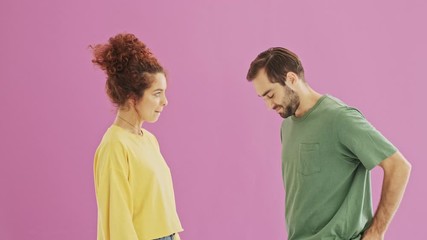 Canvas Print - Handsome young bearded man feeling embarrassed while making marriage proposal to his girlfriend. Surprised cute young redhead woman becoming happy because of marriage proposal from her boyfriend