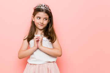 Wall Mural - Little girl wearing a princess look making up plan in mind, setting up an idea.