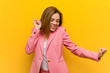 © Asier - Young fashion business woman dancing and having fun.