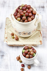 Sticker - Jug of gooseberry on wooden table.