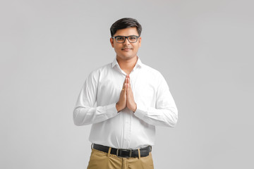 Sticker - Young Indian man with praying on White background. Gesture concept