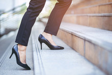Modern Businesswoman Working Woman Close Up Legs Walking Up The Stairs In Modern City In Rush Hour To Work In Office A Hurry. During The First Morning Of Work. Leave Space For Writing Descriptive Text