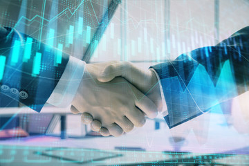 Multi exposure of financial graph on office background with two businessmen handshake. Concept of success in business