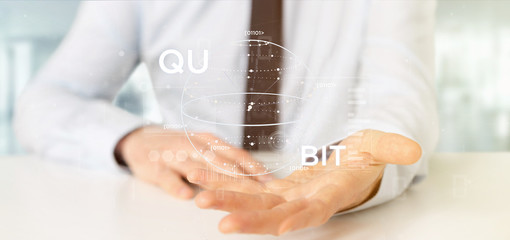 Wall Mural - businessman holding quantum computing concept with qubit icon 3d rendering