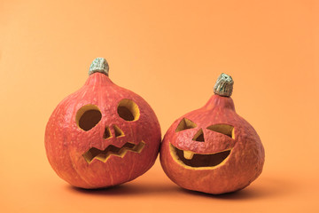 spooky carved Halloween pumpkins on orange background