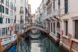 Fototapeta Przestrzenne - Boats on narrow canal between colorful historic houses in Venice.